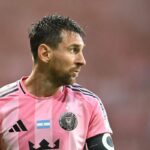 Lionel Messi en acción durante un partido de fútbol con una expresión de dolor en su rostro