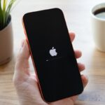Persona revisando alerta sísmica en smartphone con ondas P y S explicadas en fondo